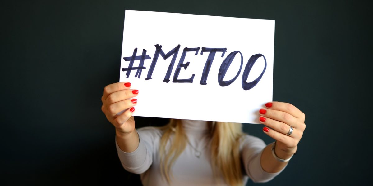 Una donna tiene un cartello con scritto #MeToo